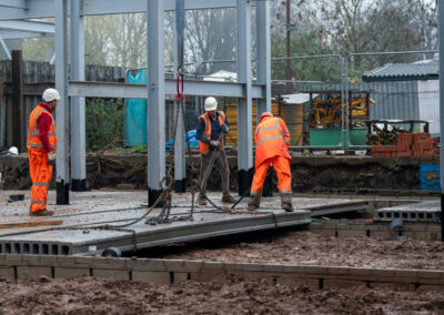 Construction contractors install hollow core floor